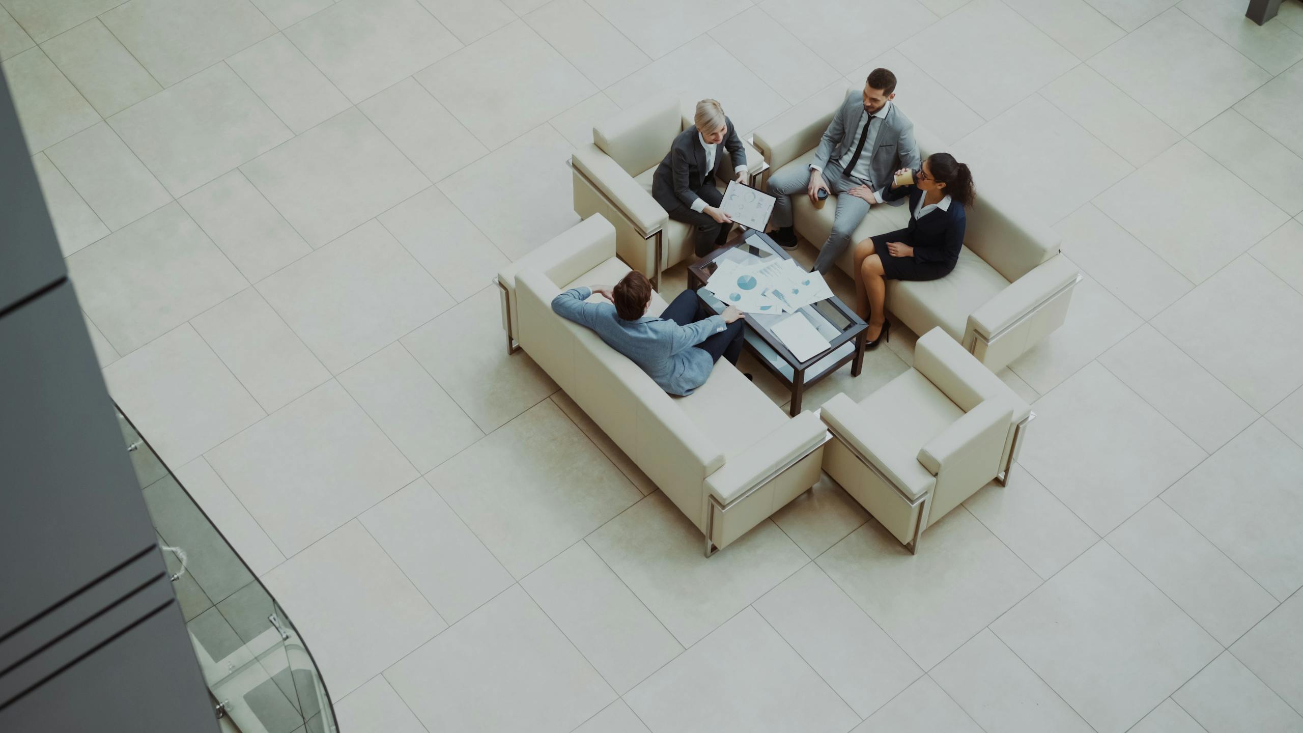 Aerial view of a group business meeting in a modern office setting.