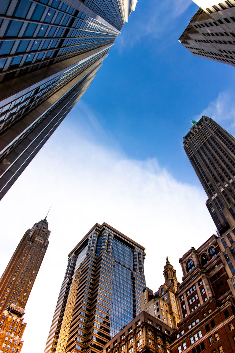Stunning view of New York City skyscrapers reaching into a vibrant blue sky, showcasing architectural grandeur.