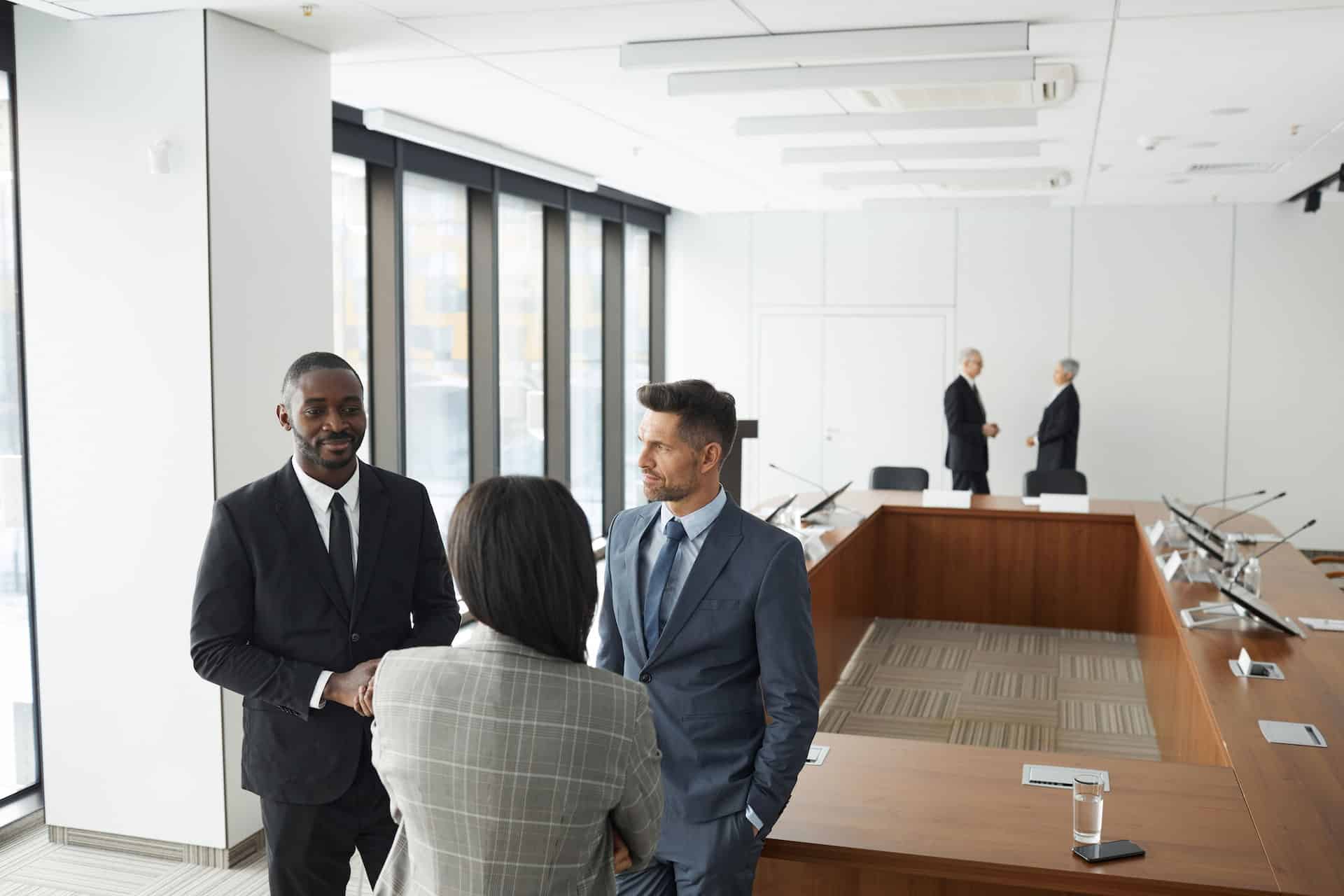 Business professionals discussing regulatory compliance in a boardroom meeting